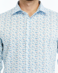 Close-up of a patterned shirt with blue and gray designs on a white background