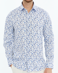 Man wearing a white shirt with blue floral pattern on a white background